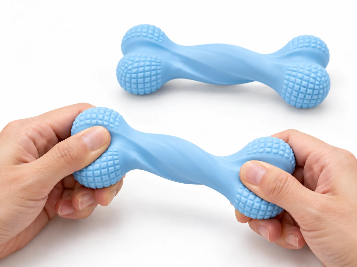 Hands bending a blue textured bone-shaped dog chew toy beside a matching toy