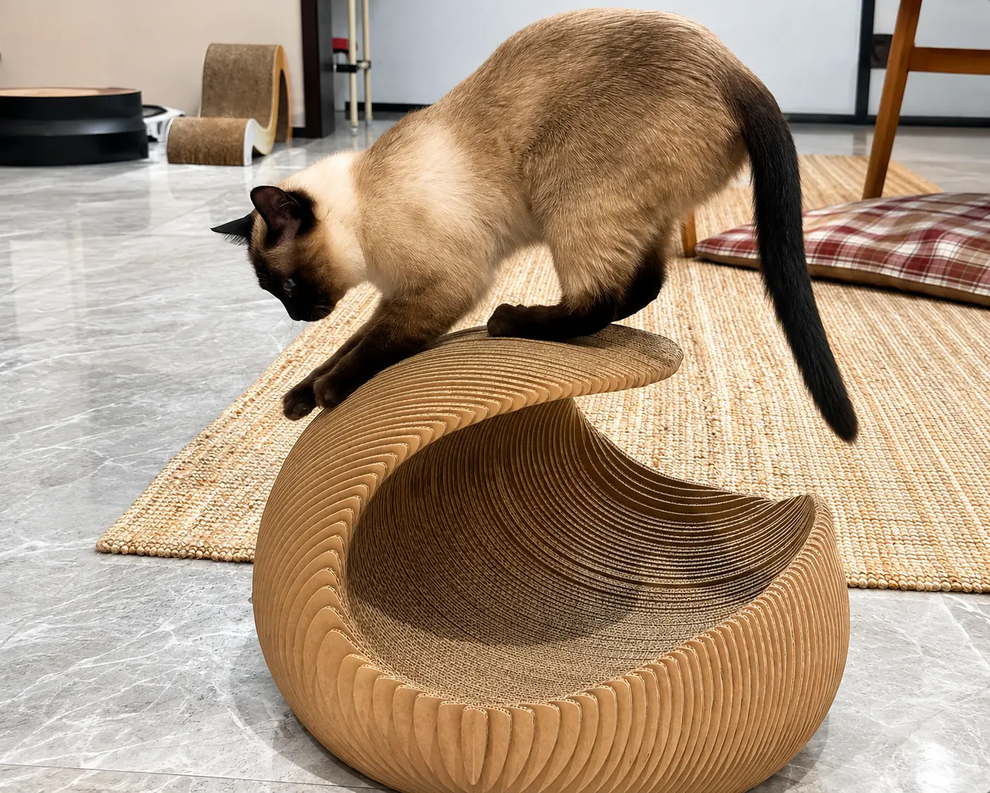 Cat using a curved cardboard scratching structure.