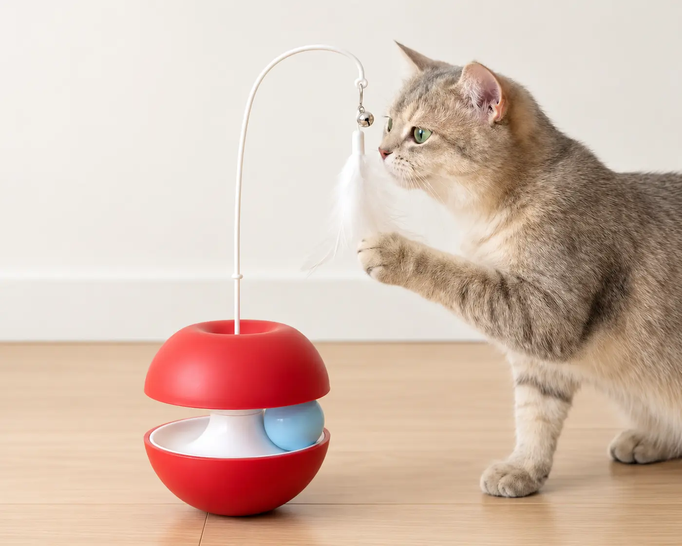 Cat playing with an interactive wobble toy.