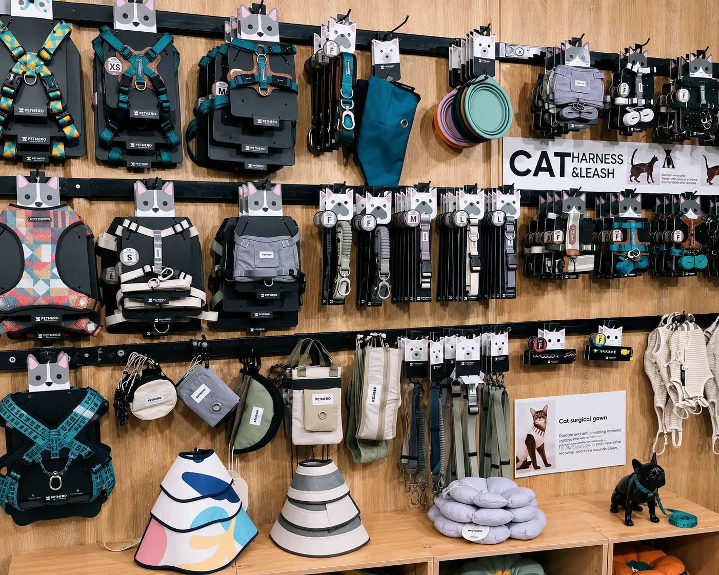 Pet product display with harnesses, leashes, collars and feeding accessories.